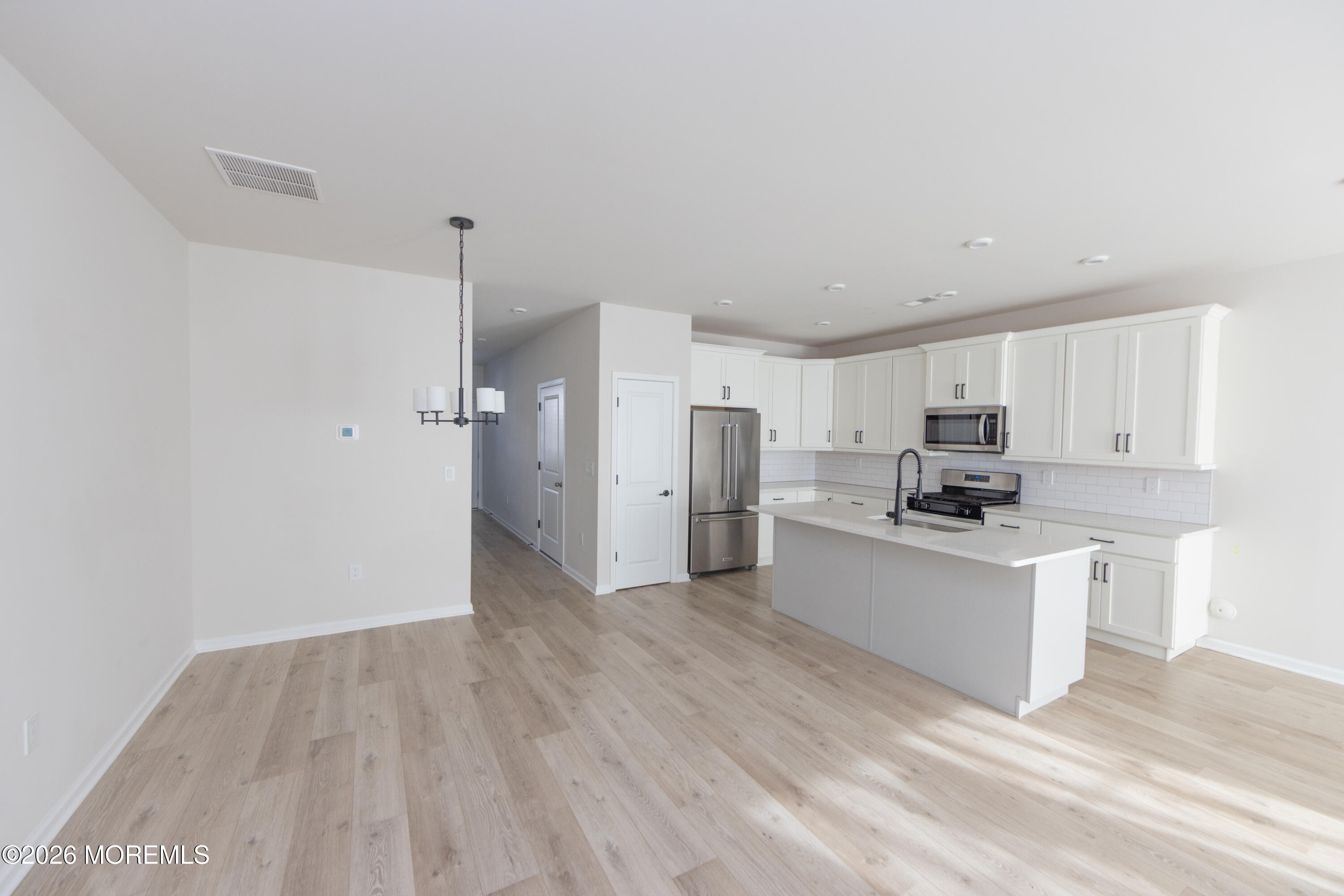 16 Chapel Lane Neptune, NJ 07753 - Photo 12 of 27 a kitchen with stainless steel appliances a refrigerator and a stove top oven