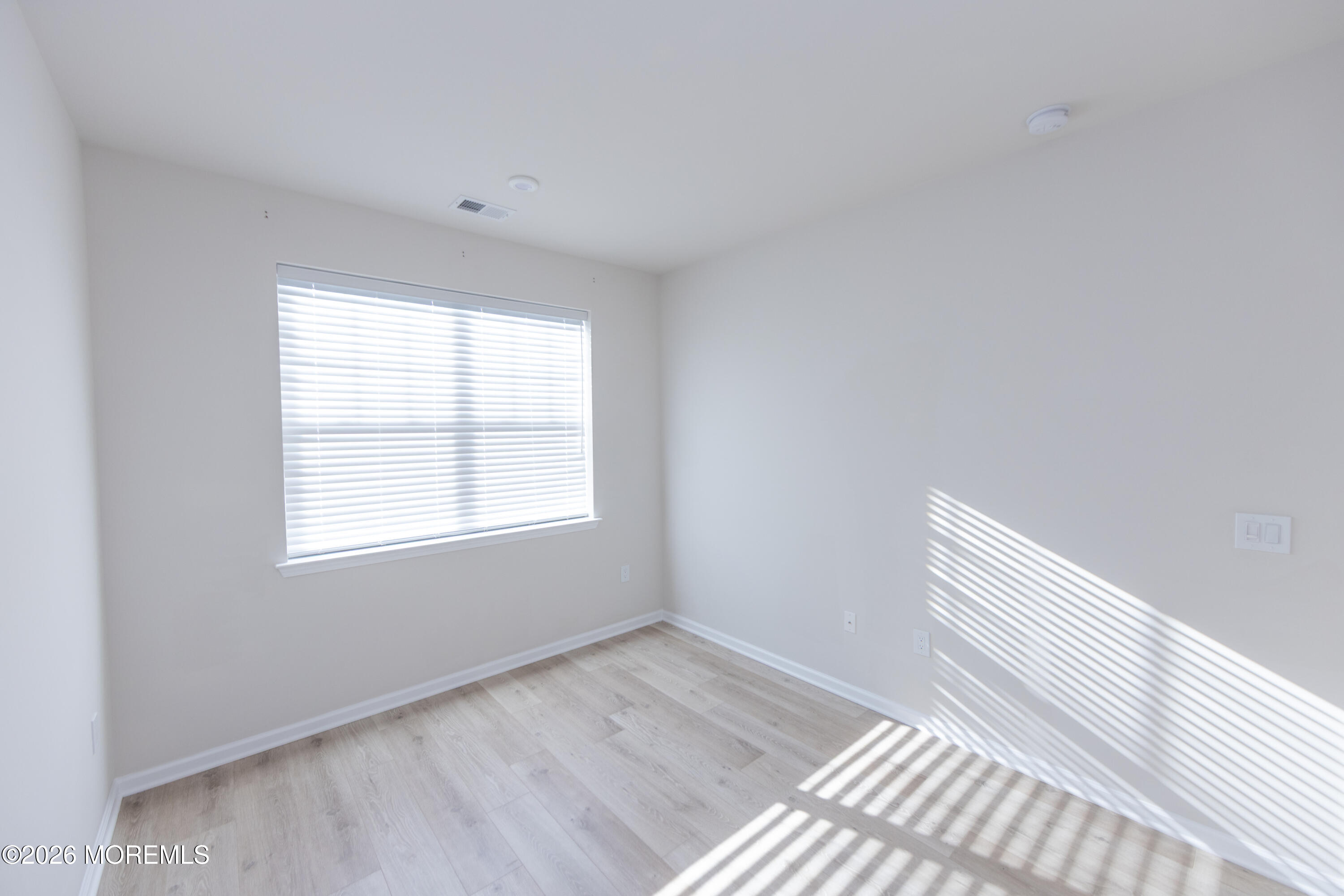 16 Chapel Lane Neptune, NJ 07753 - Photo 16 of 27 an empty room with wooden floor and windows