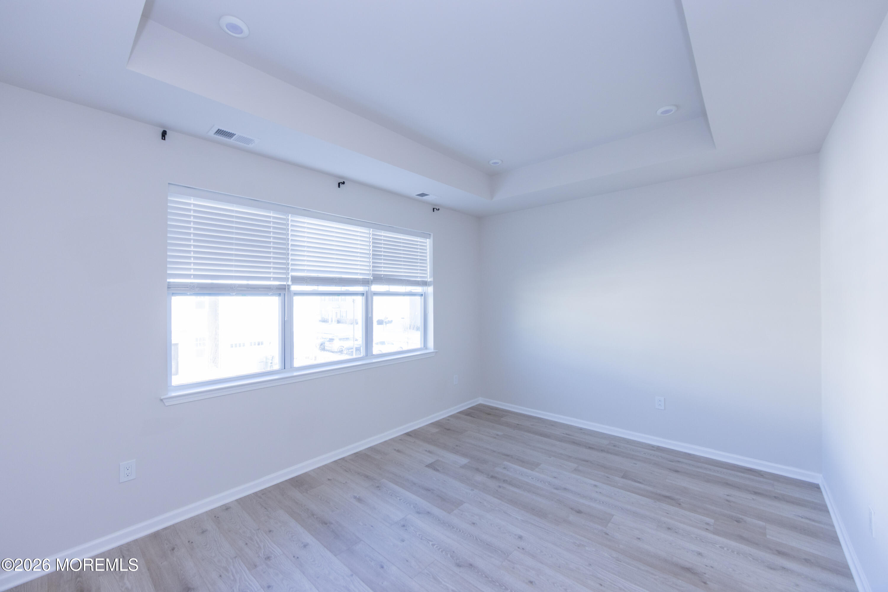 16 Chapel Lane Neptune, NJ 07753 - Photo 18 of 27 an empty room with wooden floor and windows