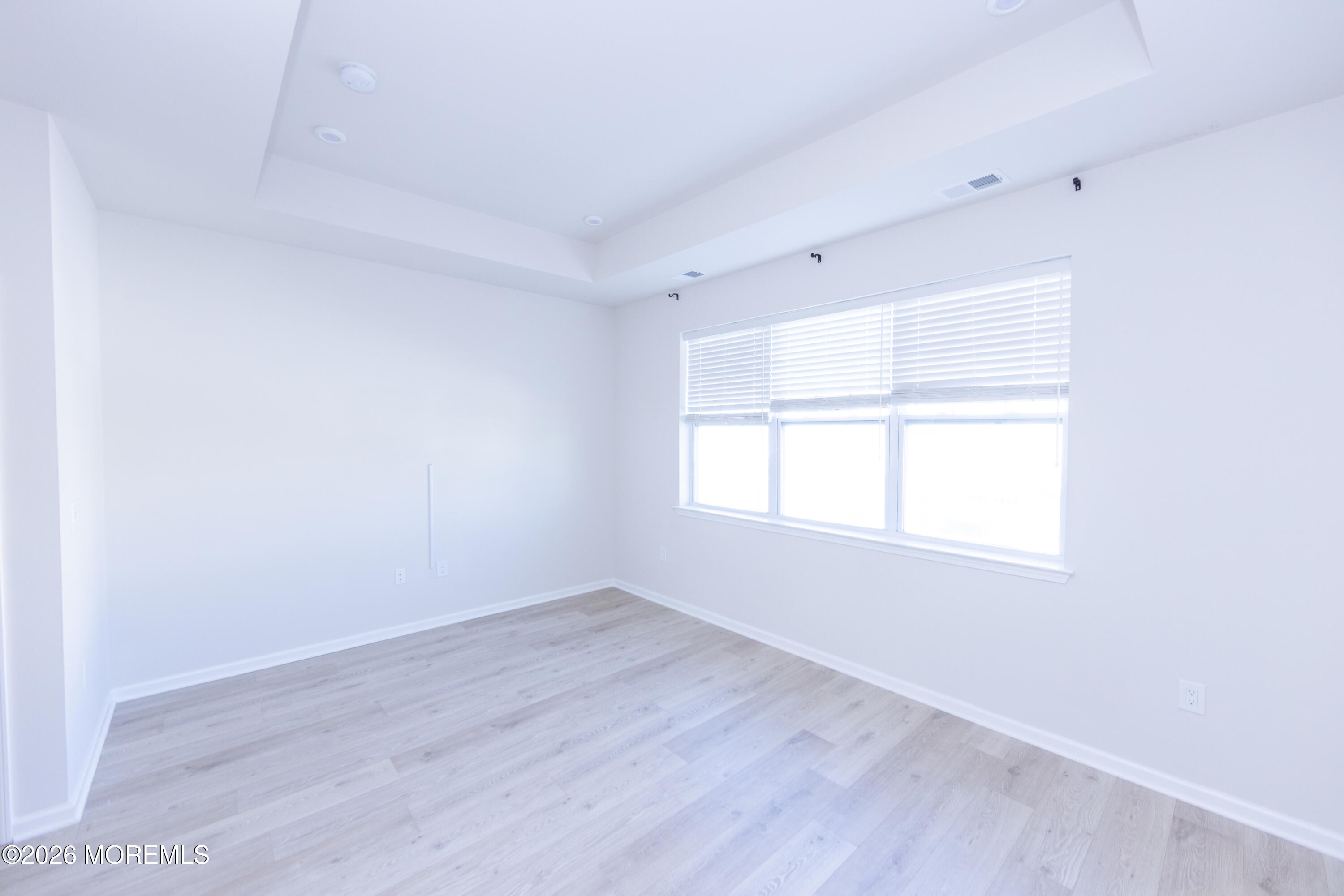16 Chapel Lane Neptune, NJ 07753 - Photo 19 of 27 an empty room with wooden floor and windows