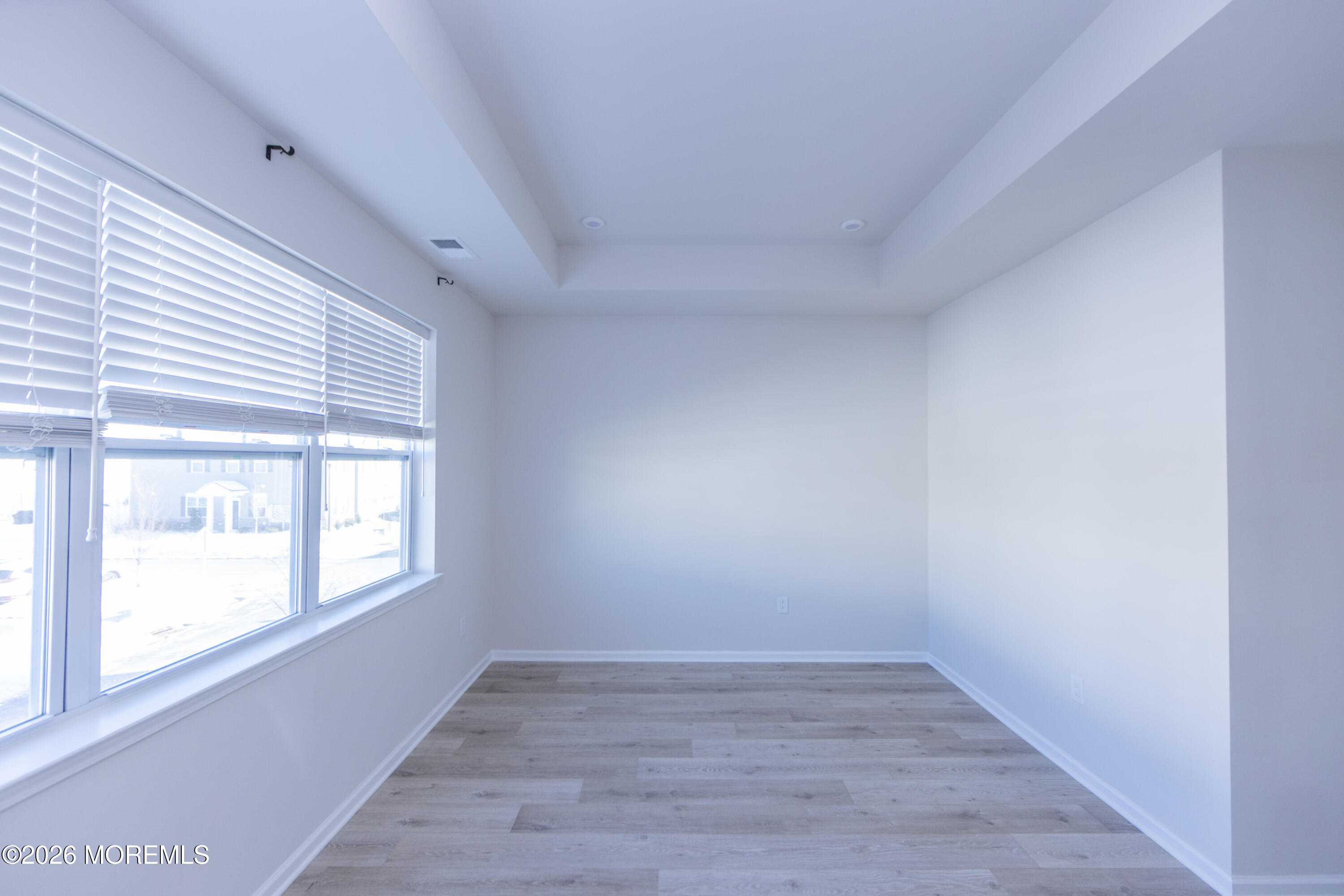 16 Chapel Lane Neptune, NJ 07753 - Photo 20 of 27 an empty room with wooden floor and windows