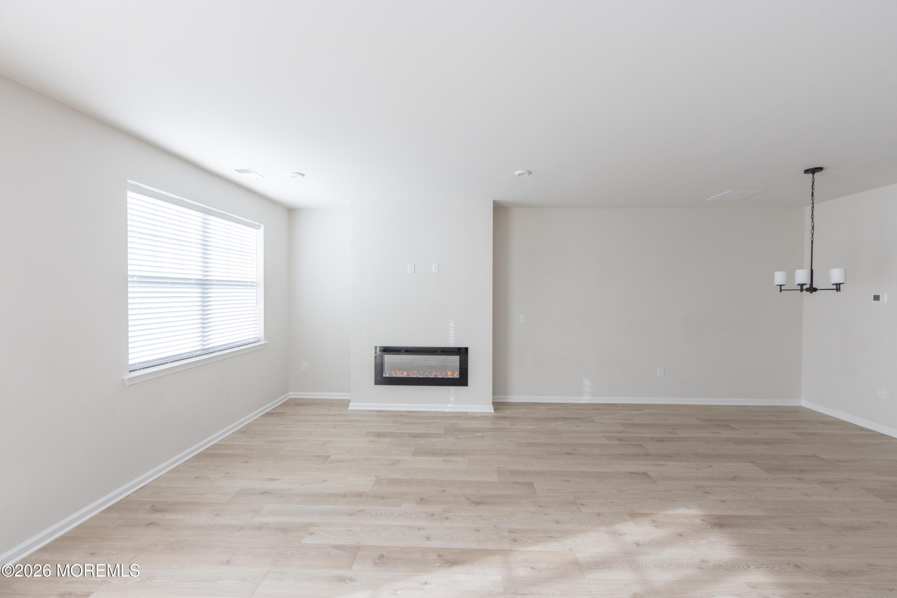 16 Chapel Lane Neptune, NJ 07753 - Photo 6 of 27 a view of an empty room with wooden floor and a window