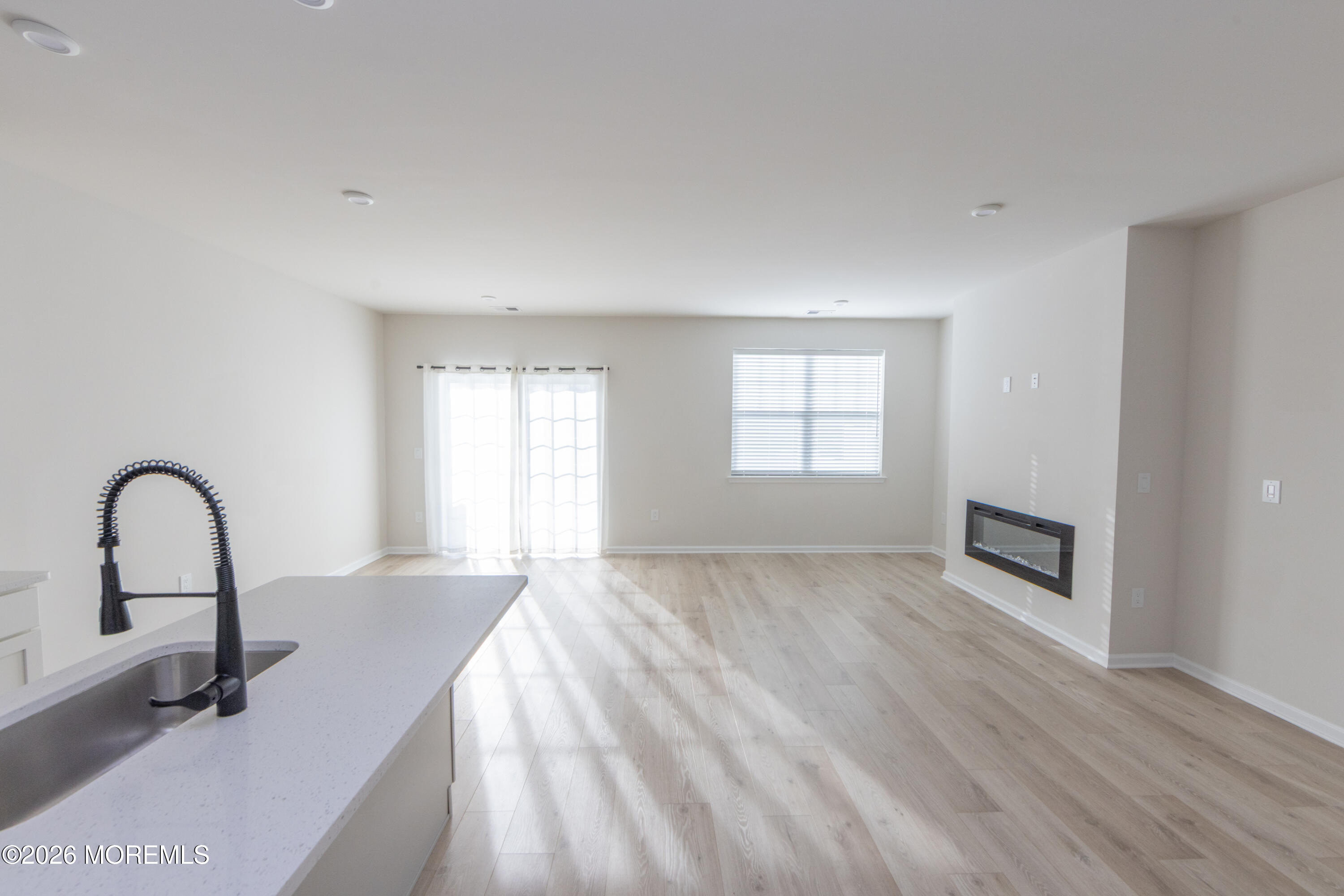 16 Chapel Lane Neptune, NJ 07753 - Photo 10 of 27 a view of empty room with wooden floor and fireplace