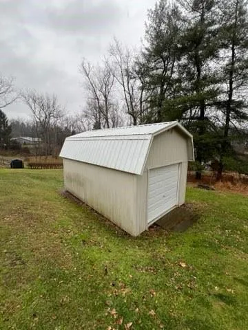 a spacious bathroom with a granite countertop sink a large mirror and a refrigerator