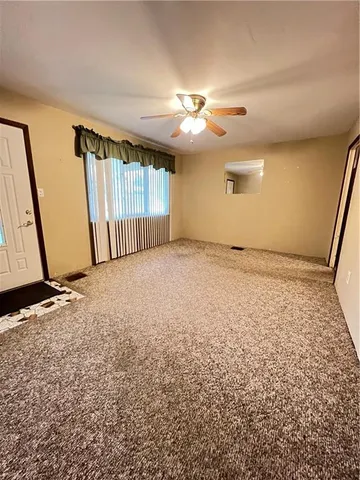 an empty room with a empty space and windows