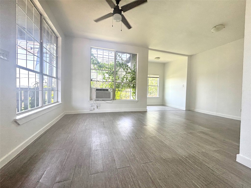 2410 East 12th Street Austin, TX 78702 - Photo 5 of 17 Empty room featuring dark wood finished floors and ceiling fan