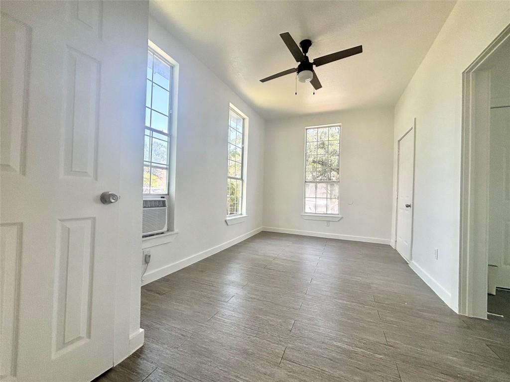 2410 East 12th Street Austin, TX 78702 - Photo 6 of 17 Unfurnished room featuring a ceiling fan and dark wood-type flooring