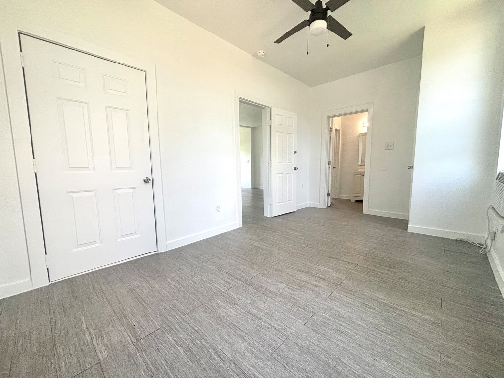 2410 East 12th Street Austin, TX 78702 - Photo 7 of 17 Unfurnished bedroom featuring ensuite bath and ceiling fan