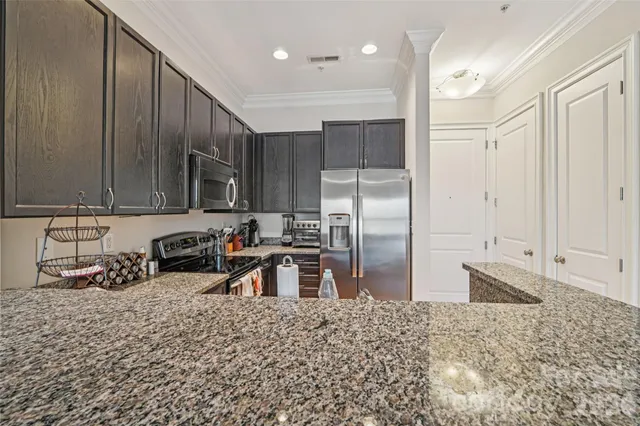 a bedroom with a bed and a flat tv screen on a dresser