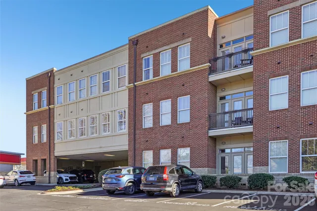 a front view of a building with parking space