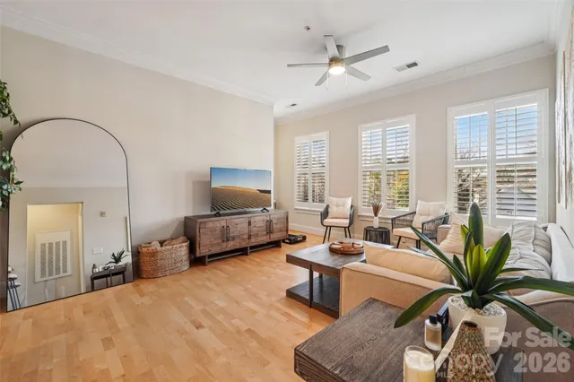 a living room with fireplace furniture and a large window