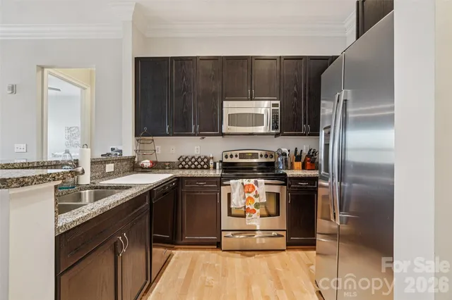 a kitchen with a refrigerator sink and stove