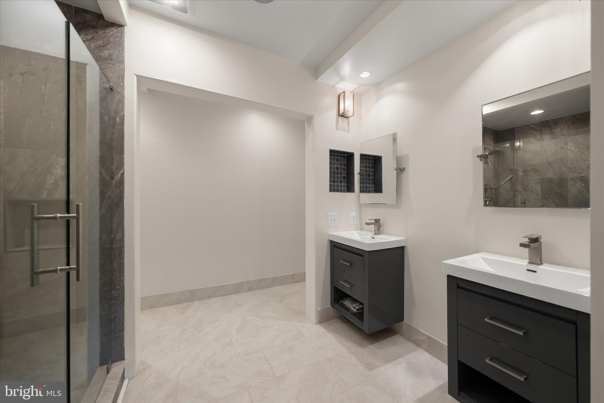 5104 Scarsdale Road Bethesda, MD 20816 - Photo 38 of 68 a bathroom with a sink double vanity and mirror