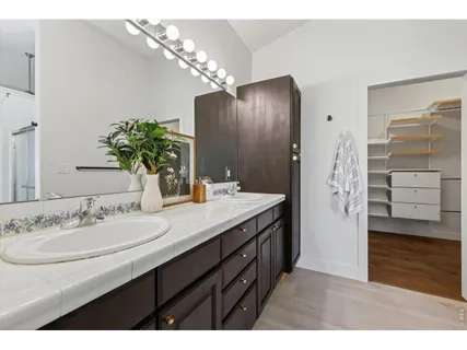 a bathroom with a sink double vanity and a shower