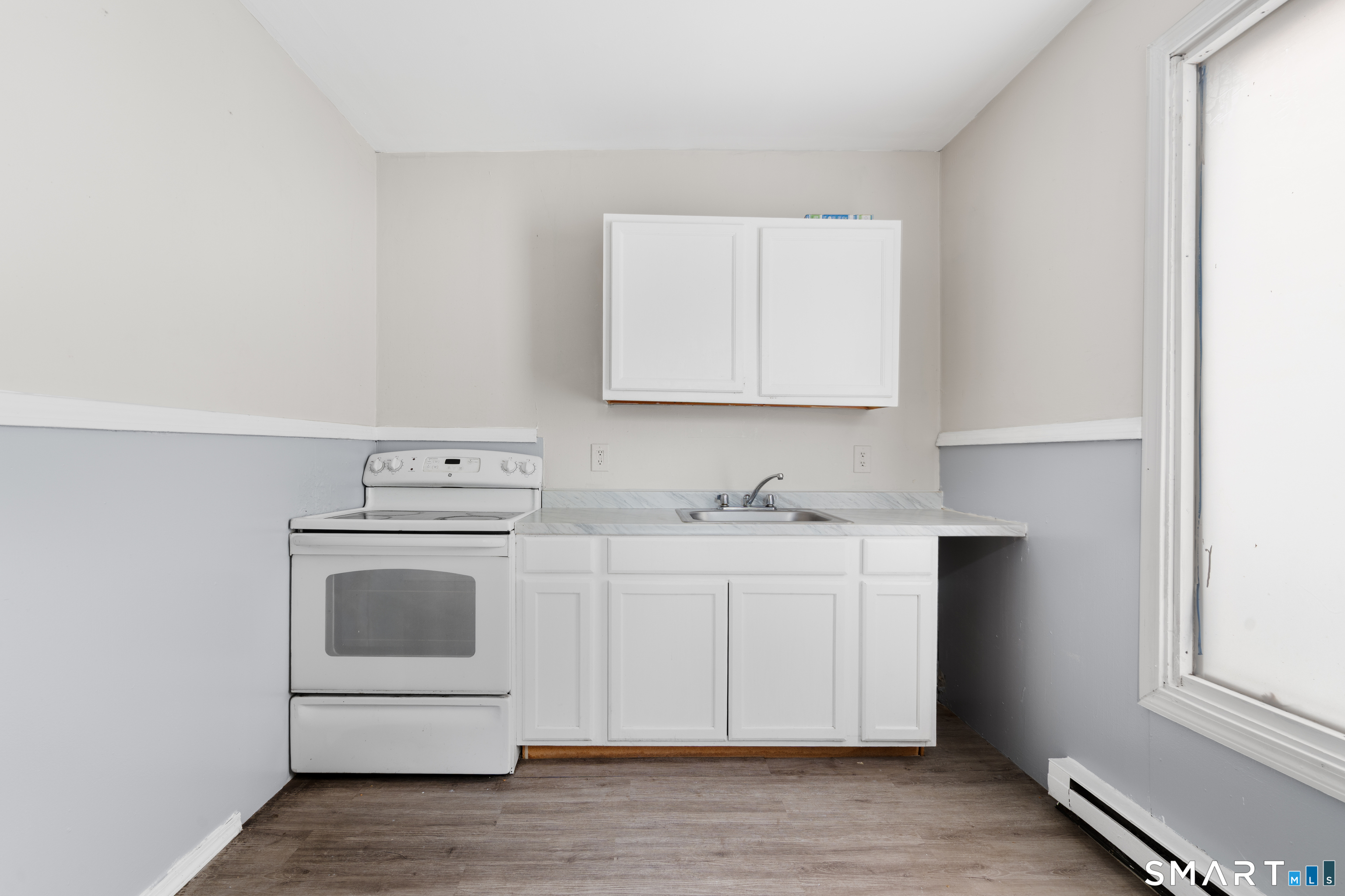 135 Prospect Street Waterbury, CT 06710 - Photo 11 of 19 a kitchen with cabinets appliances a sink and a window