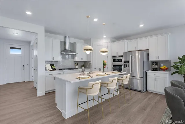 a kitchen that has a lot of cabinets a sink and appliances in it