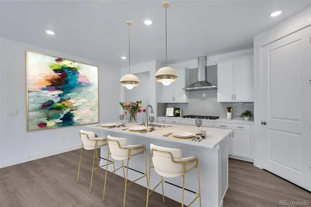 a kitchen with stainless steel appliances kitchen island a table and chairs in it