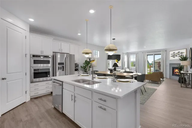 a kitchen with stainless steel appliances granite countertop a stove refrigerator and cabinets