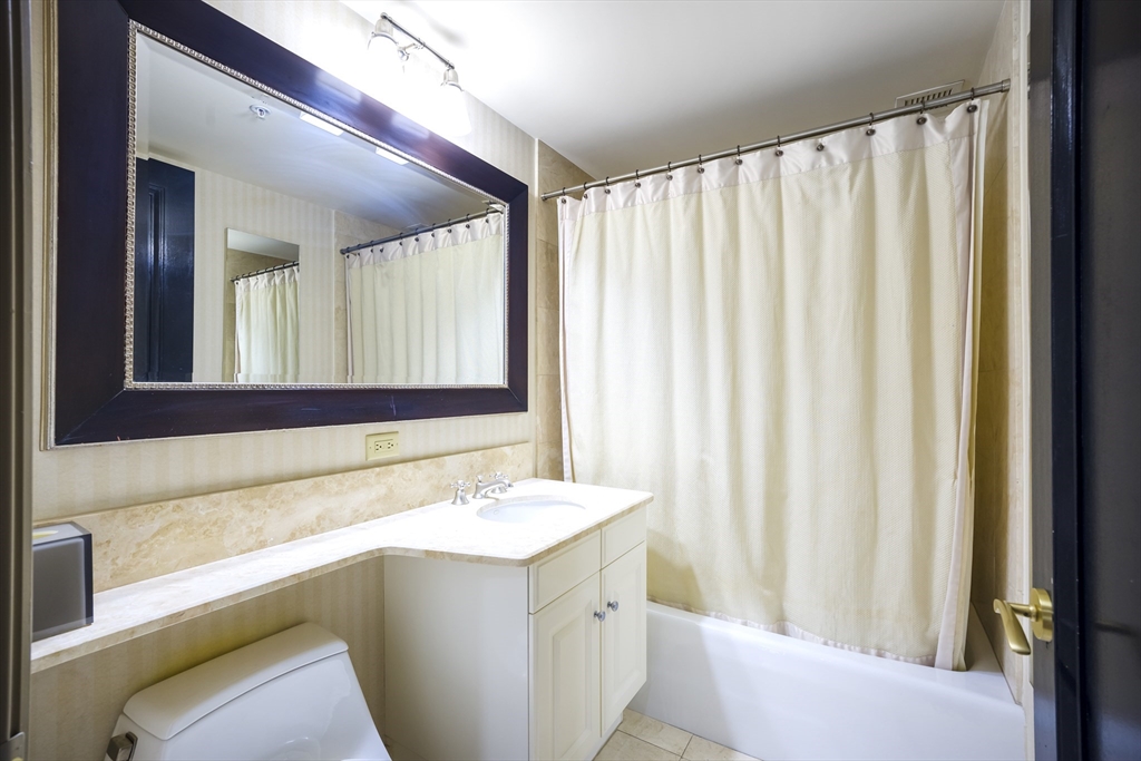 3 Avery Street, Unit 804 Boston, MA 02111 - Photo 11 of 21 a bathroom with a sink and a mirror