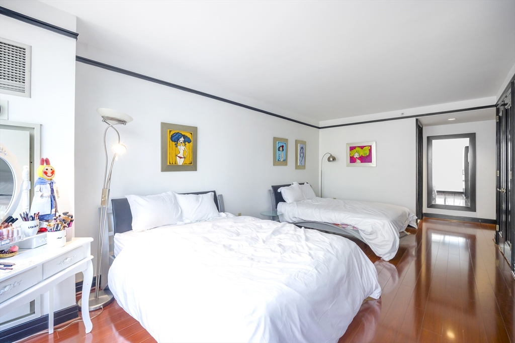 3 Avery Street, Unit 804 Boston, MA 02111 - Photo 12 of 21 a bedroom with double bed and a dresser