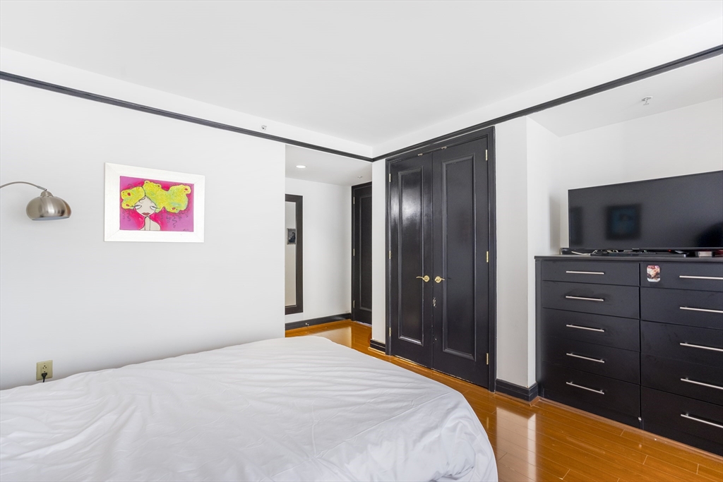 3 Avery Street, Unit 804 Boston, MA 02111 - Photo 13 of 21 a bedroom with a bed and a flat screen tv