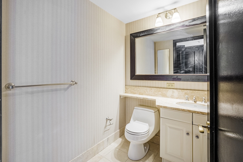 3 Avery Street, Unit 804 Boston, MA 02111 - Photo 14 of 21 a bathroom with a toilet sink and mirror