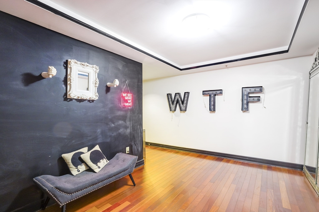 3 Avery Street, Unit 804 Boston, MA 02111 - Photo 20 of 21 a living room with couch and painting on the wall