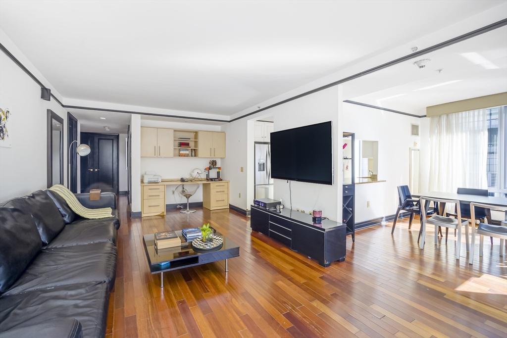 3 Avery Street, Unit 804 Boston, MA 02111 - Photo 2 of 21 a living room with furniture and a flat screen tv