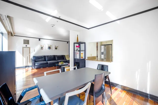 a view of a dining room with furniture and a potted plant