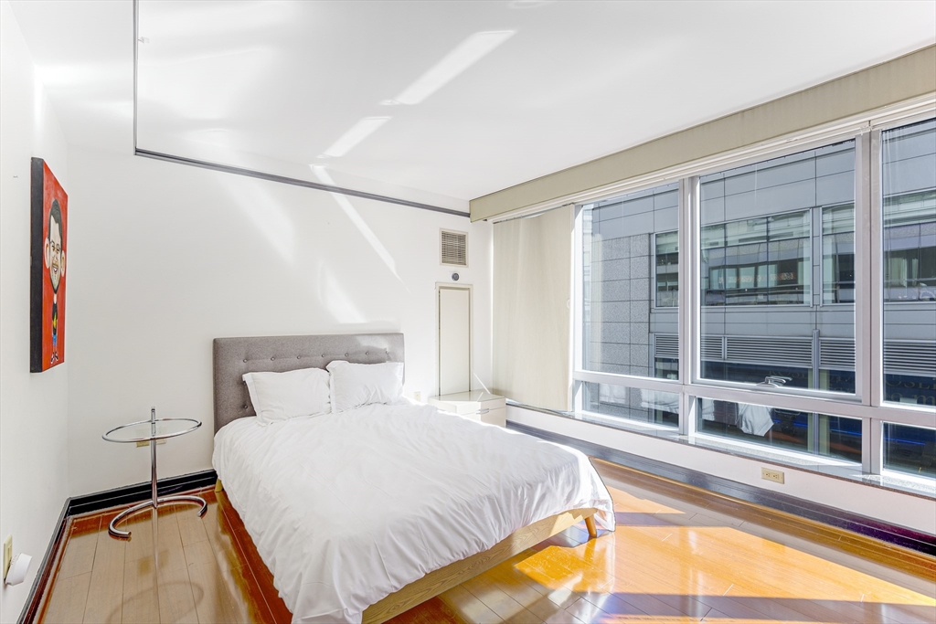 3 Avery Street, Unit 804 Boston, MA 02111 - Photo 9 of 21 a bedroom with a bed and a large window