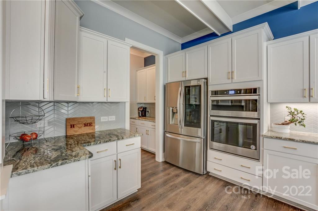 1106 Currituck Way York, SC 29745 - Photo 11 of 45 a kitchen with granite countertop white cabinets and stainless steel appliances