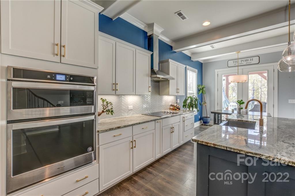 1106 Currituck Way York, SC 29745 - Photo 12 of 45 a kitchen with granite countertop white cabinets stainless steel appliances and a counter space