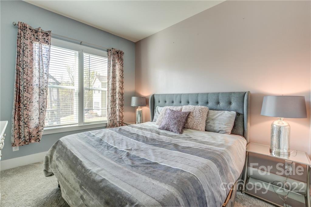 1106 Currituck Way York, SC 29745 - Photo 18 of 45 a bedroom with a bed and a night stand