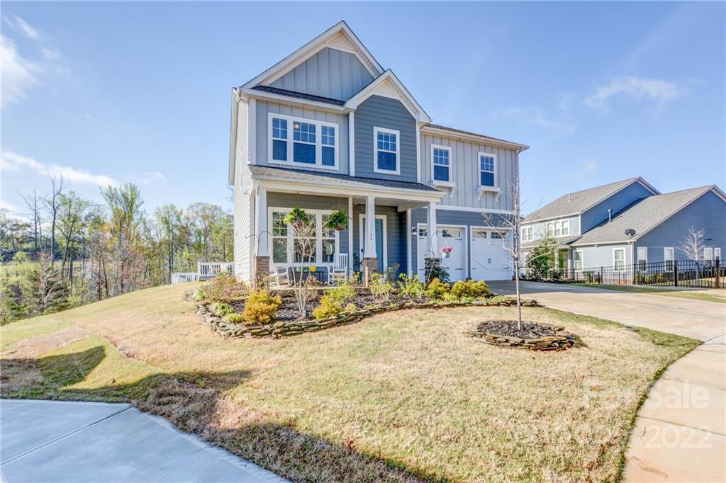 1106 Currituck Way York, SC 29745 - Photo 2 of 45 a view of a white house with a swimming pool and sitting area