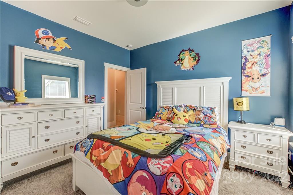 1106 Currituck Way York, SC 29745 - Photo 25 of 45 a bedroom with a bed and a dresser in it