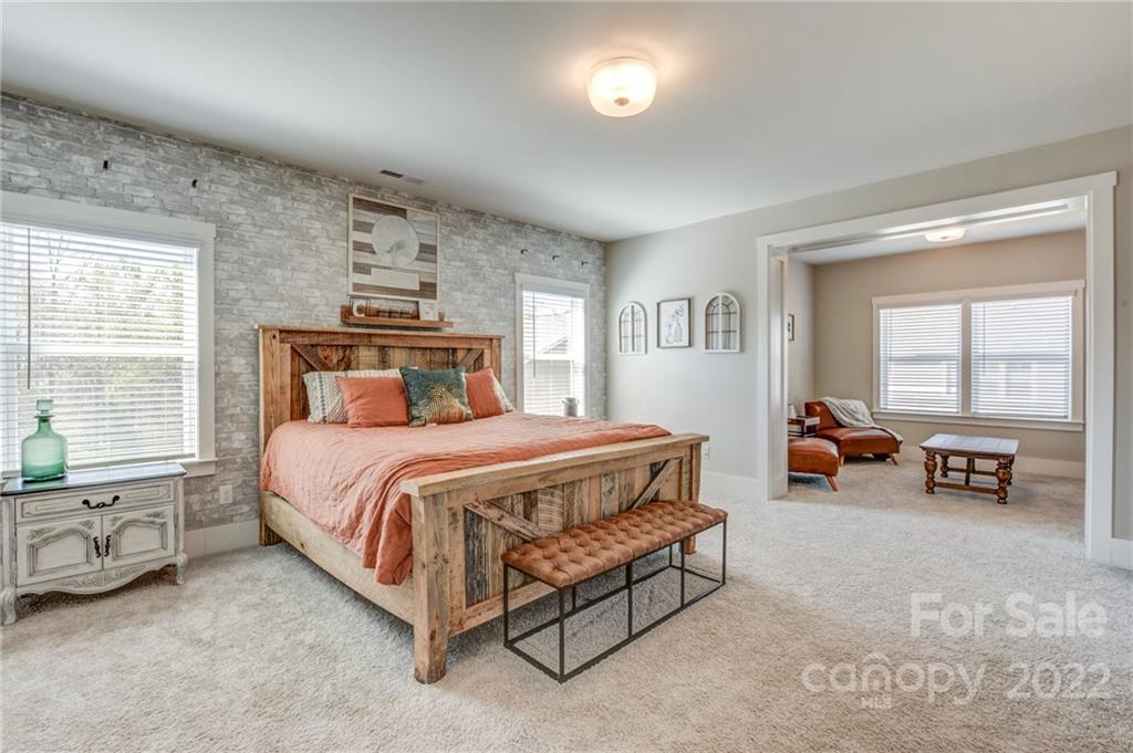 1106 Currituck Way York, SC 29745 - Photo 34 of 45 a spacious bedroom with a bed and a car parked in it