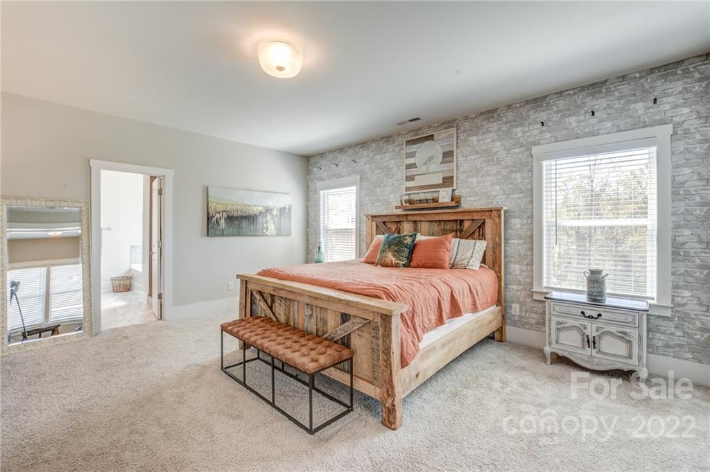 1106 Currituck Way York, SC 29745 - Photo 36 of 45 a bedroom with a bed a table and with a large window