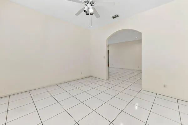 a view of a room with a white wall and a chandelier
