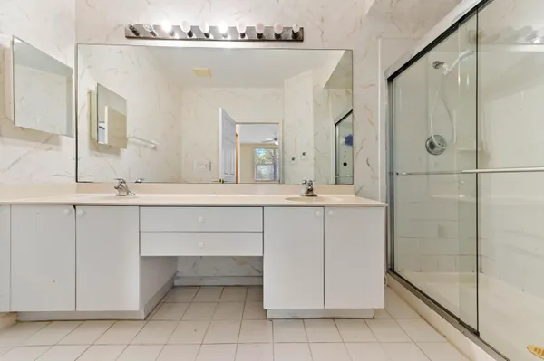 a bathroom with a sink vanity and a mirror