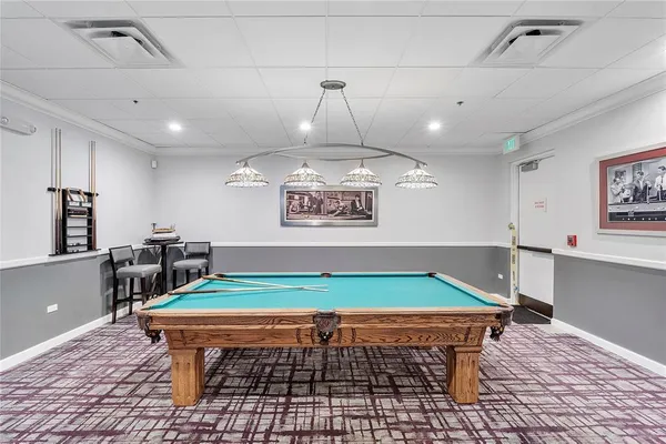 a room with wooden furniture and pool table