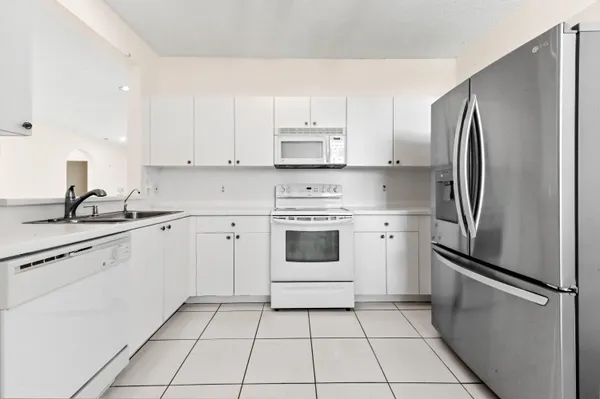 a kitchen with cabinets stainless steel appliances and a counter space