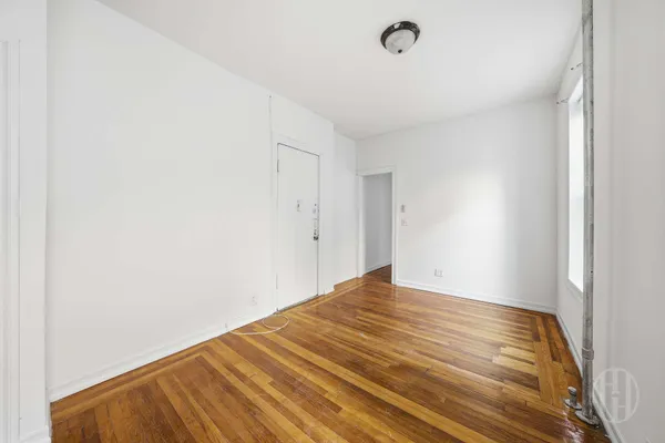 a view of a big room with wooden floor and staircase