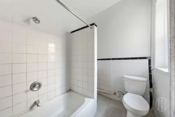 a kitchen with a refrigerator and a sink