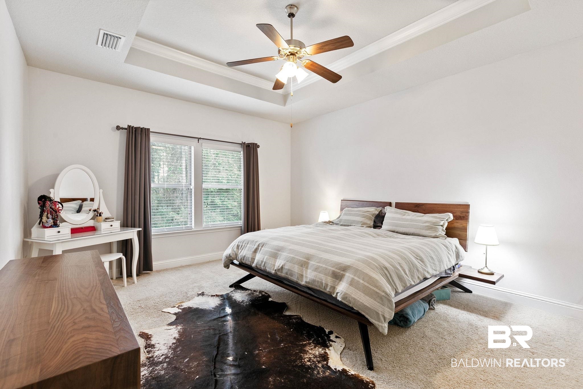 31350 Hoot Owl Road Daphne, AL 36527 - Photo 24 of 94 Bedroom with carpet floors, ceiling fan, crown molding, and a tray ceiling