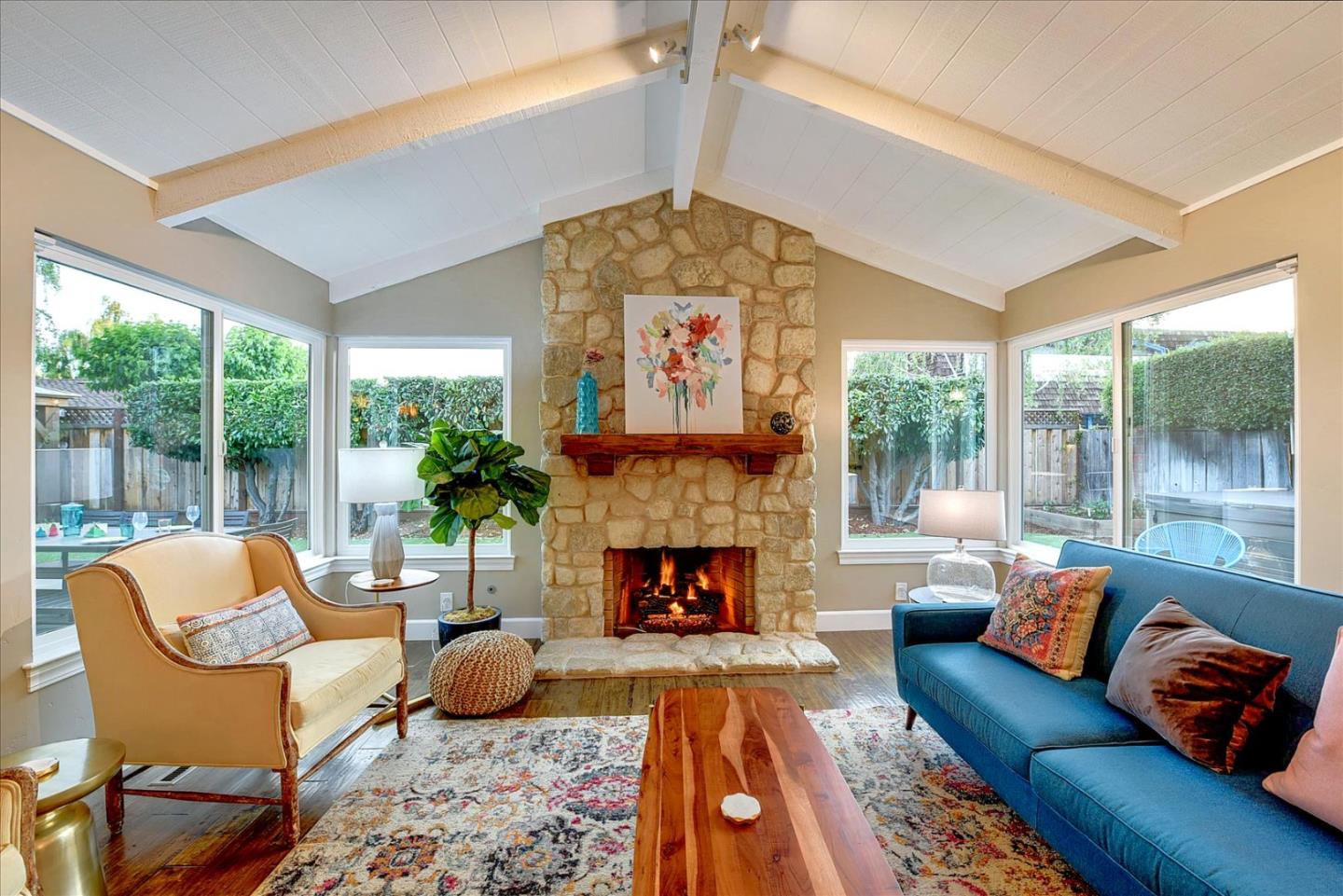 a living room with furniture large window and fireplace
