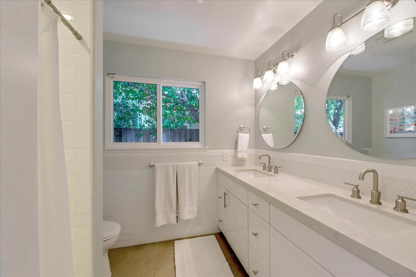 2215 Constitution Drive San Jose, CA 95124 - Photo 19 of 36 a bathroom with a double vanity sink and a mirror