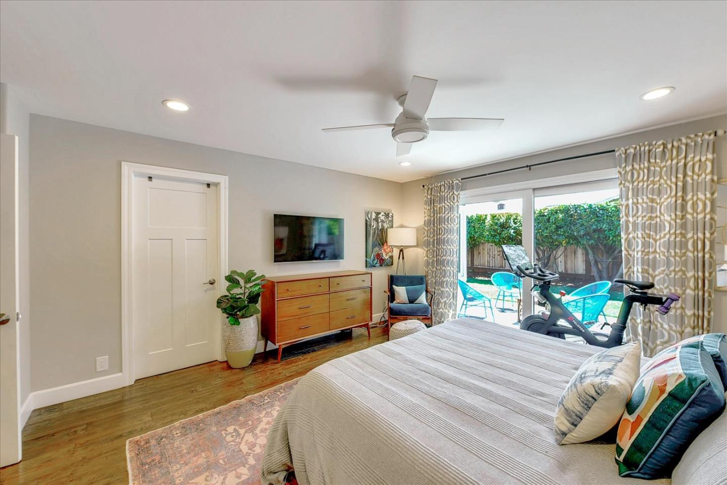 2215 Constitution Drive San Jose, CA 95124 - Photo 22 of 36 a bedroom with a bed a large window and a chandelier