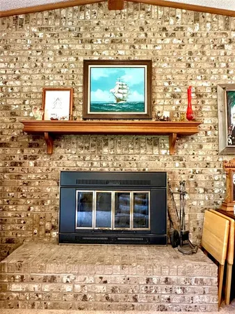a living room with a fireplace and a flat screen tv