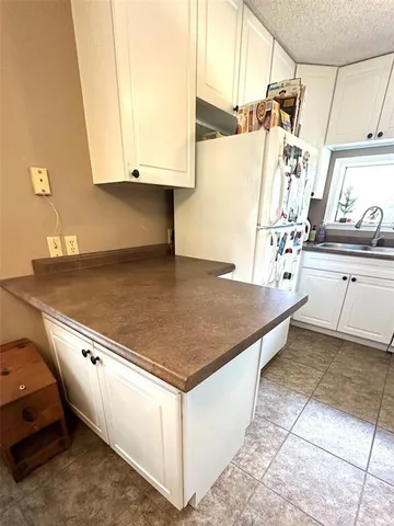 a stove top oven sitting inside of a kitchen