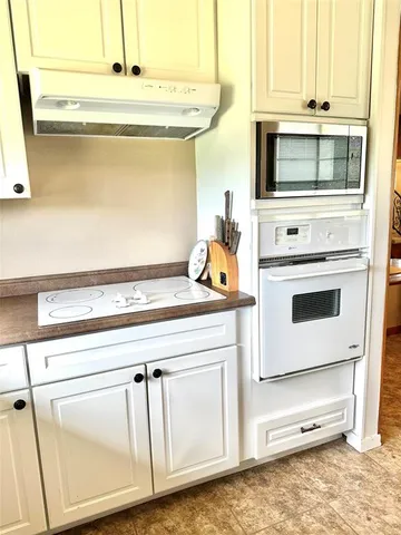 a kitchen with stainless steel appliances a white stove top oven and a refrigerator